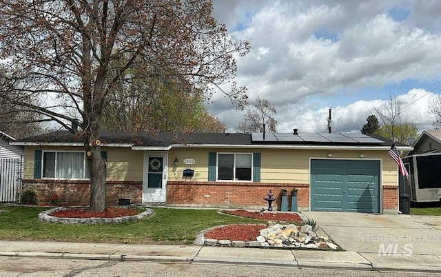 1932 W Panama St, Boise, ID 83705 - ranch-style home featuring brick siding, an attached garage, driveway, roof mounted solar panels, and a front lawn