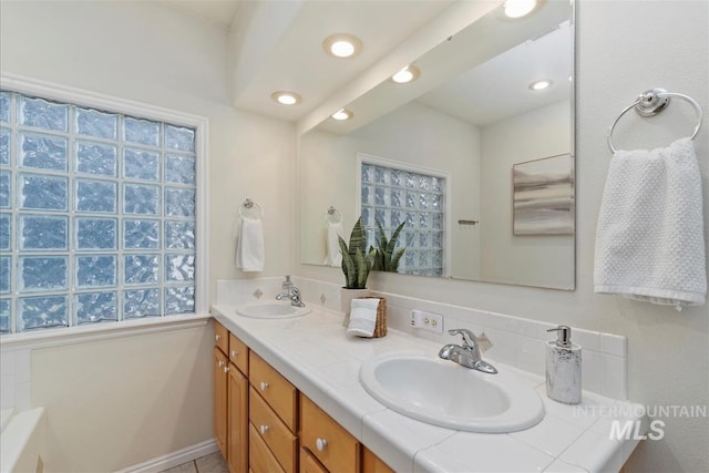 full bathroom featuring double vanity, a sink, and recessed lighting