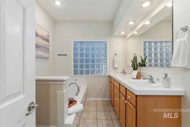 full bathroom featuring a sink, a garden tub, recessed lighting, and double vanity