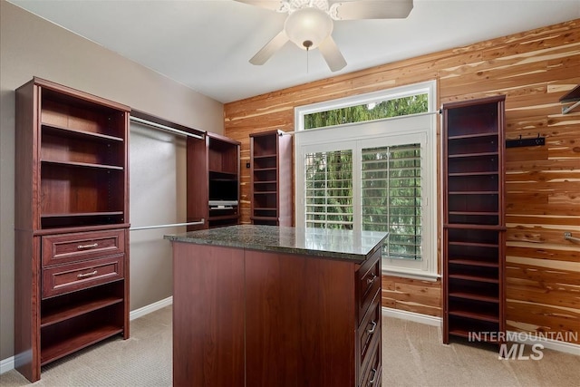 walk in closet featuring ceiling fan and light carpet