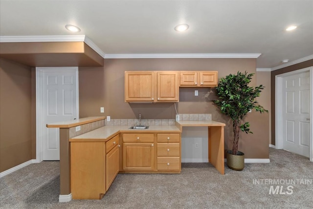 kitchen featuring light countertops, baseboards, light carpet, and a peninsula