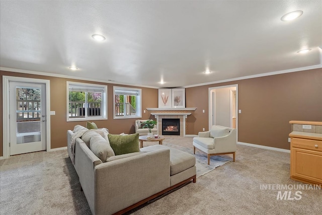 living area with baseboards, ornamental molding, light carpet, and a tile fireplace