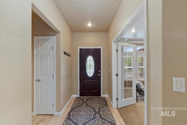 entrance foyer featuring baseboards and light wood finished floors