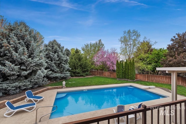 view of swimming pool with a lawn, a patio, a fenced in pool, and a fenced backyard