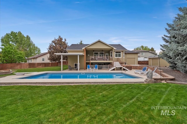 back of property with a fenced backyard, a fenced in pool, stairs, and a patio