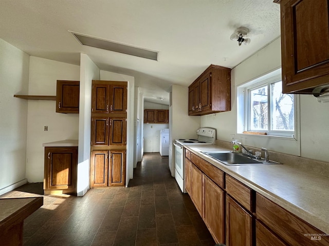 kitchen with electric stove, lofted ceiling, washer / clothes dryer, and sink