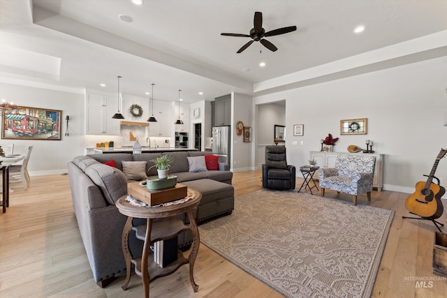 4337 W Ravenna St, Meridian, ID 83646 - living area featuring recessed lighting, a raised ceiling, a ceiling fan, light wood-style floors, and a chandelier