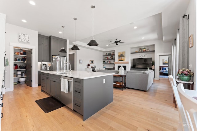 4337 W Ravenna St, Meridian, ID 83646 - kitchen featuring appliances with stainless steel finishes, gray cabinets, a ceiling fan, light countertops, and light wood-style flooring