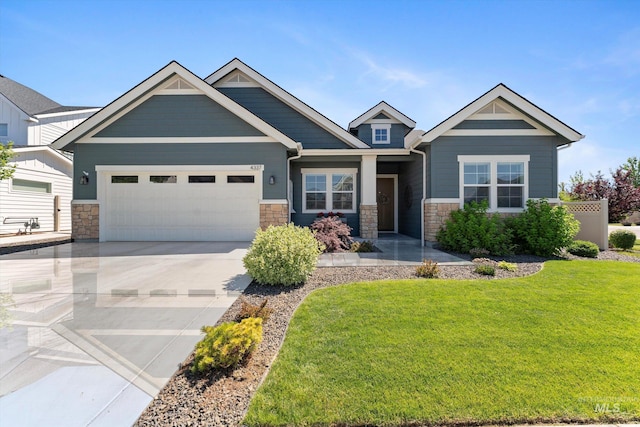 4337 W Ravenna St, Meridian, ID 83646 - craftsman-style house featuring stone siding, an attached garage, a front lawn, and driveway