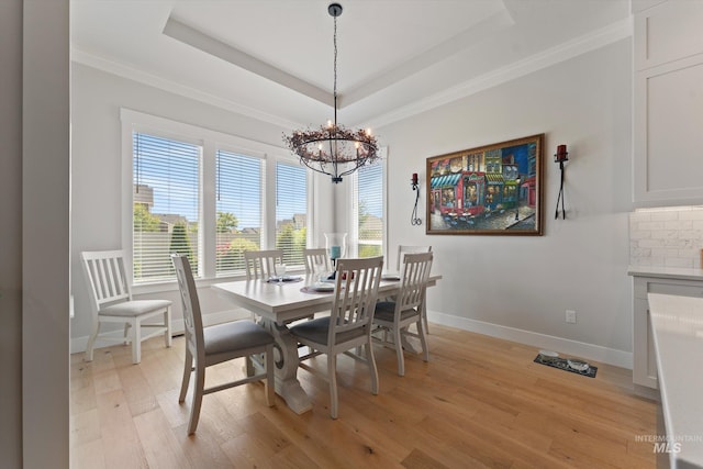 4337 W Ravenna St, Meridian, ID 83646 - dining room featuring light wood finished floors, crown molding, a chandelier, and a tray ceiling