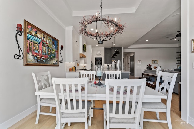 4337 W Ravenna St, Meridian, ID 83646 - dining space featuring a raised ceiling, light wood finished floors, a chandelier, a ceiling fan, and recessed lighting