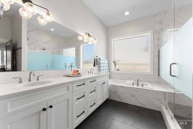 4337 W Ravenna St, Meridian, ID 83646 - bathroom with a marble finish shower, a garden tub, double vanity, decorative backsplash, and tile patterned flooring