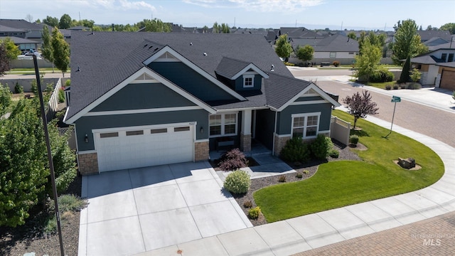 4337 W Ravenna St, Meridian, ID 83646 - craftsman inspired home featuring stone siding, concrete driveway, an attached garage, a residential view, and a front yard