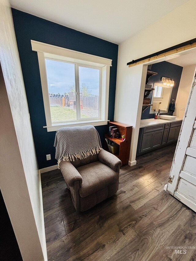 802 S 9th St, Rupert, ID 83350 - living area featuring dark wood-style floors, a barn door, and baseboards
