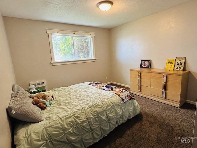 802 S 9th St, Rupert, ID 83350 - bedroom with dark colored carpet, baseboards, and a textured ceiling