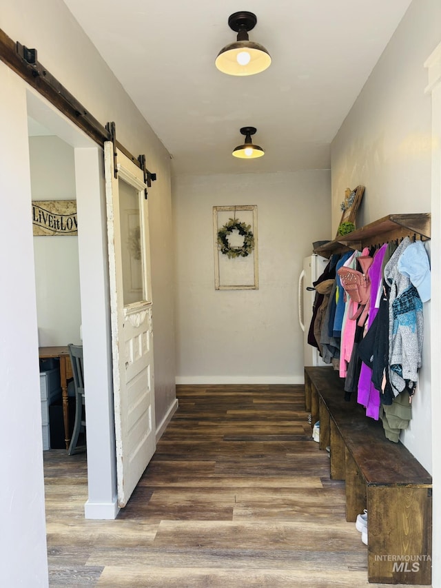 802 S 9th St, Rupert, ID 83350 - mudroom featuring a barn door, wood finished floors, and baseboards