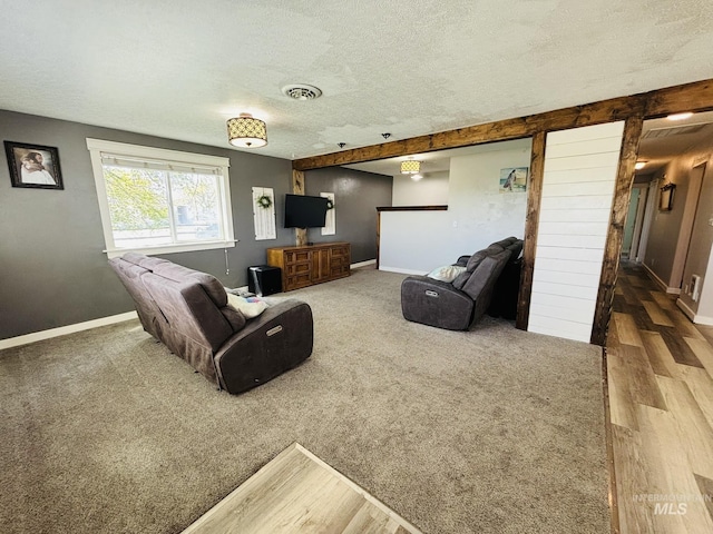 802 S 9th St, Rupert, ID 83350 - carpeted living area with a textured ceiling, baseboards, and wood finished floors