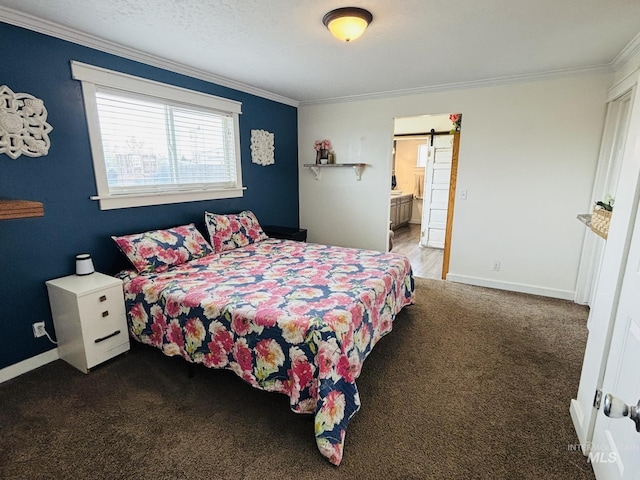 802 S 9th St, Rupert, ID 83350 - carpeted bedroom featuring ornamental molding, a barn door, baseboards, and ensuite bathroom