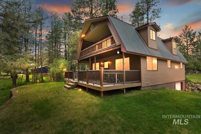 76 W Castle Creek Rd, Garden Valley, ID 83622 - back of property with a balcony, a yard, metal roof, and a garage