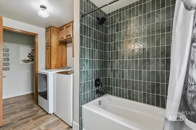 76 W Castle Creek Rd, Garden Valley, ID 83622 - full bathroom featuring washing machine and dryer, shower / bathtub combination with curtain, wood finished floors, and baseboards