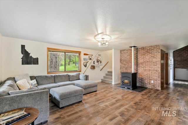 76 W Castle Creek Rd, Garden Valley, ID 83622 - living area featuring stairs, wood finished floors, and a wood stove