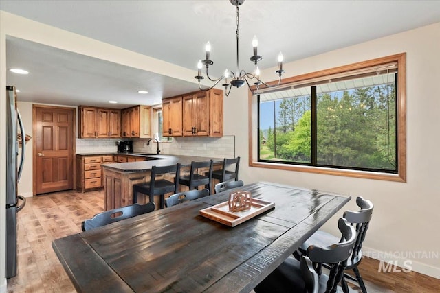 76 W Castle Creek Rd, Garden Valley, ID 83622 - dining area with a chandelier, baseboards, light wood-style flooring, and recessed lighting