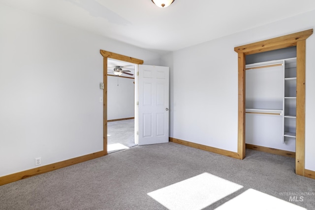 unfurnished bedroom featuring carpet, a closet, and baseboards
