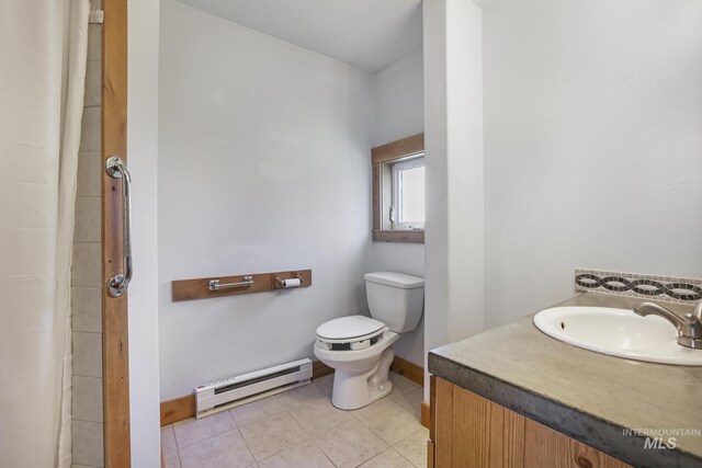 full bath with a baseboard heating unit, toilet, baseboards, tile patterned flooring, and vanity