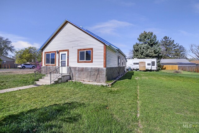 bungalow-style home featuring fence and a front yard