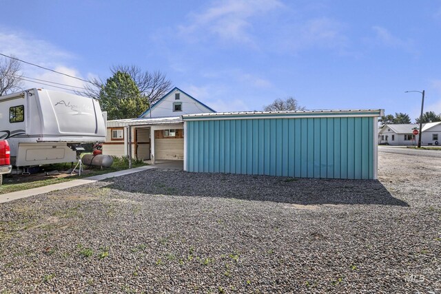 view of side of home with a carport and metal roof