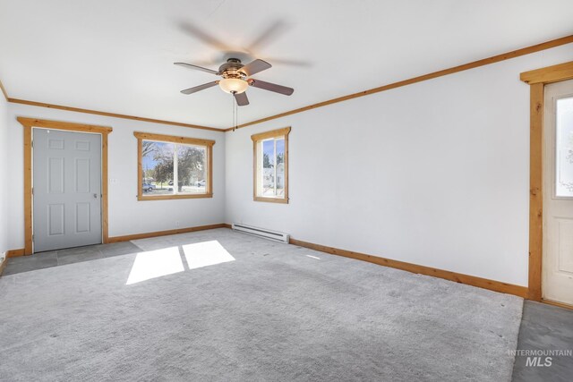 carpeted spare room featuring ceiling fan, baseboards, a baseboard radiator, and crown molding