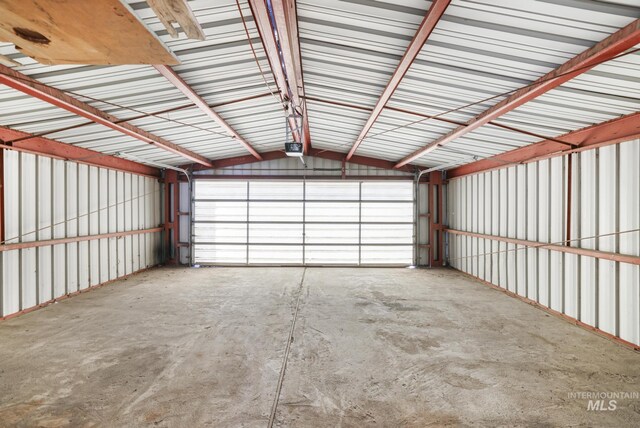 garage featuring a garage door opener and metal wall