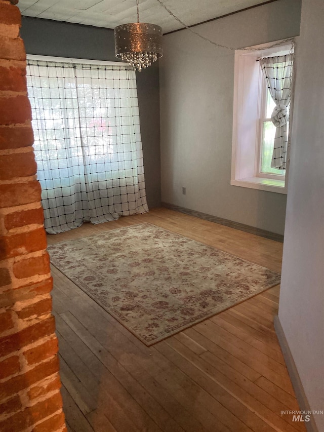 interior space with hardwood / wood-style flooring and an inviting chandelier