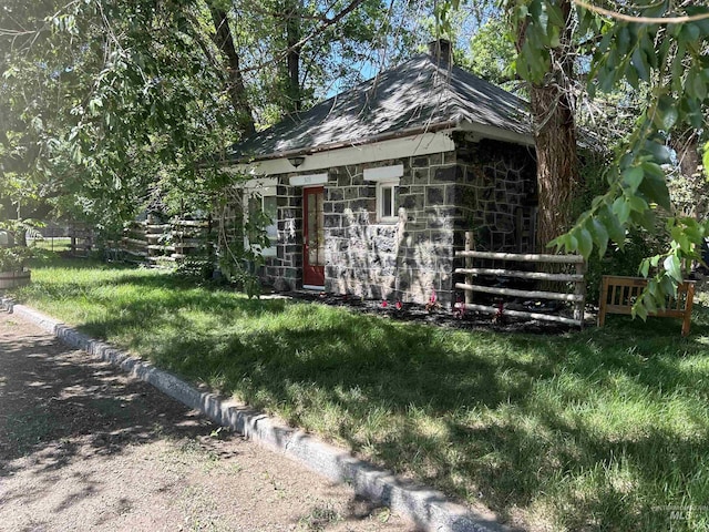 view of outbuilding with a yard