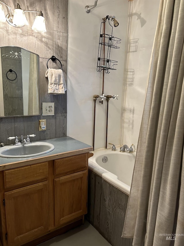 bathroom featuring vanity and a washtub