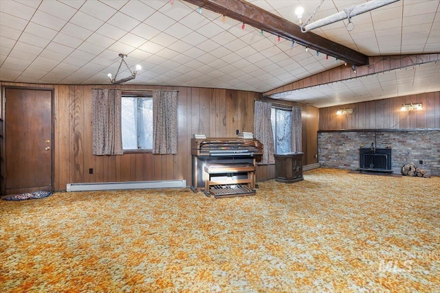 kitchen with carpet floors, a baseboard radiator, wooden walls, and lofted ceiling with beams