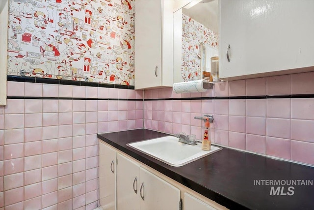 bathroom with a wainscoted wall and vanity