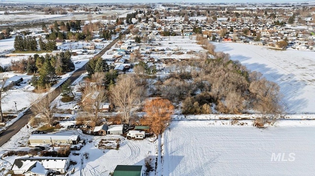 snowy aerial view featuring a residential view