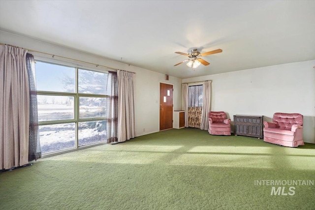 unfurnished room featuring carpet flooring and a ceiling fan