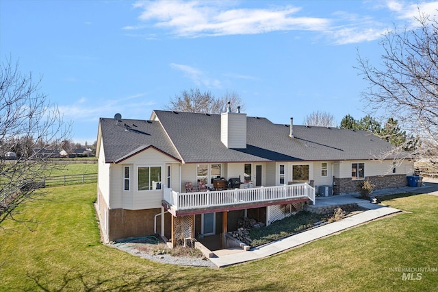 520 9th St, Middleton, ID 83644 - back of house with a chimney, a deck, fence, a lawn, and central AC