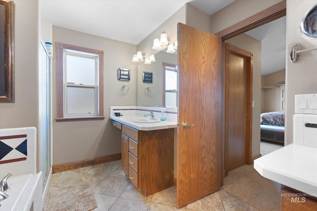 520 9th St, Middleton, ID 83644 - bathroom featuring connected bathroom, baseboards, a bathing tub, and vanity