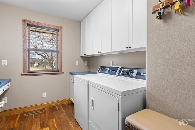 520 9th St, Middleton, ID 83644 - washroom with dark wood-style flooring, cabinet space, washing machine and dryer, and visible vents