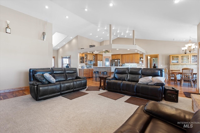 520 9th St, Middleton, ID 83644 - living room featuring high vaulted ceiling, a chandelier, light wood finished floors, visible vents, and recessed lighting