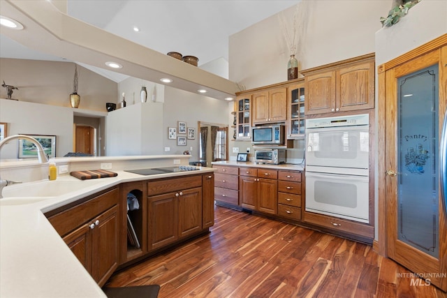 520 9th St, Middleton, ID 83644 - kitchen featuring high vaulted ceiling, light countertops, double oven, brown cabinets, and stainless steel microwave