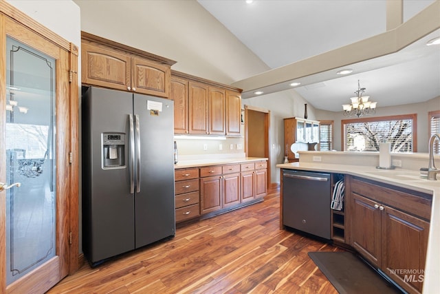 520 9th St, Middleton, ID 83644 - kitchen with light countertops, vaulted ceiling, stainless steel appliances, a sink, and wood finished floors