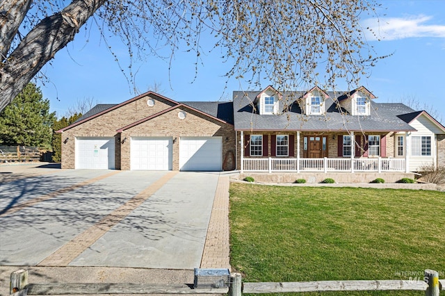 520 9th St, Middleton, ID 83644 - view of front facade featuring a garage, concrete driveway, brick siding, a front lawn, and a porch