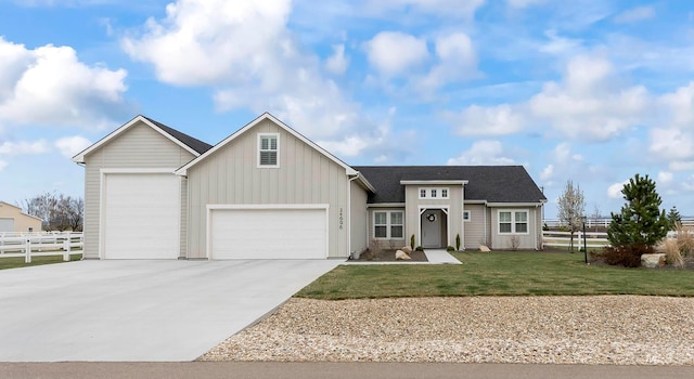 24696 Regal Rd, Middleton, ID 83644 - view of front of home with board and batten siding, fence, a front lawn, an attached garage, and concrete driveway