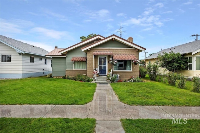705 H St, Rupert, ID 83350 - bungalow-style home featuring a chimney, a front yard, and brick siding