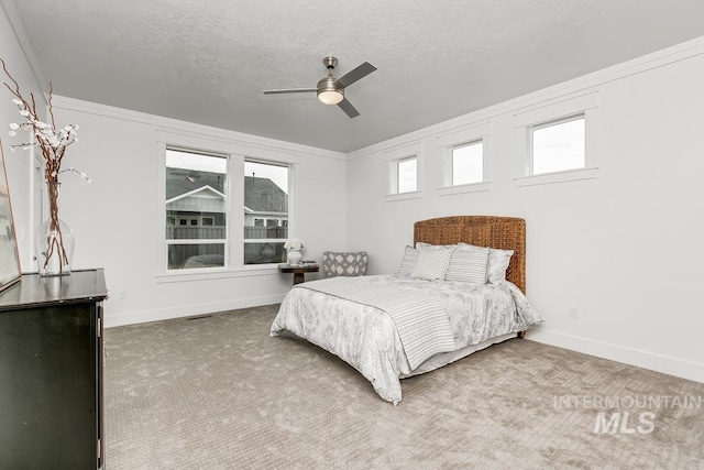 bedroom featuring crown molding, ceiling fan, and carpet flooring