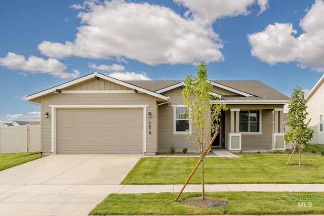 view of front of house featuring a garage and a front lawn